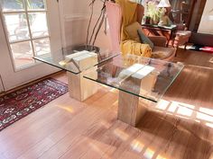 a glass table sitting on top of a hard wood floor