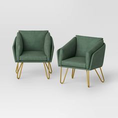 two green chairs with gold legs and one chair in the shape of a rectangle