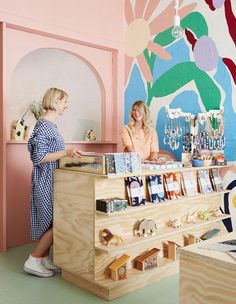 two women standing in front of a store counter