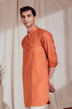 Featuring a patch pocket with contrasting bartack, a Mandarin collar in keeping with the contemporary trends, and contrasting placket on one side, this is no ordinary kurta. Available in off-white/brown and rust/natural, the Zeroun Kurta is for the man with a distinguished taste. This 100% linen kurta is perfect for those formal evenings or a family dinner during the sweltering Indian summers. Casual Long Sleeve Brown Kurta, Casual Brown Long Sleeve Kurta, Casual Straight Kurta For Work, Casual Cotton Kurta For Fall, Casual Long Sleeve Kurta With Pockets, Casual Long-sleeve Kurta With Pockets, Casual Fall Cotton Kurta, Orange Cotton Long Sleeve Kurta, Long Sleeve Orange Cotton Kurta