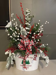 a christmas planter with holly and berries