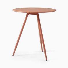 a small round table with wooden legs and a pink top on an isolated white background