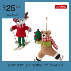 two stuffed animals are on skis and one is holding a christmas ornament