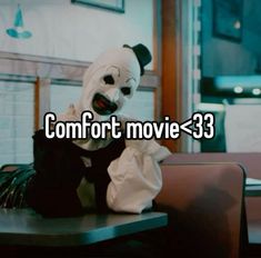 a person in a mask sitting at a table with the words comfort movie - 33