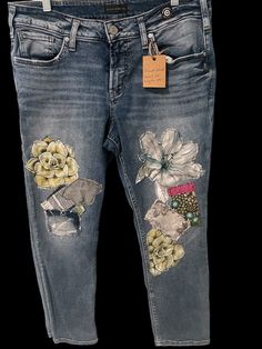 a pair of jeans with flowers on them