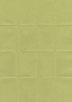 a piece of paper that is green and has some writing on the side of it