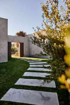 an outdoor area with grass and stepping stones