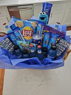 a basket filled with snacks and drinks on top of a counter