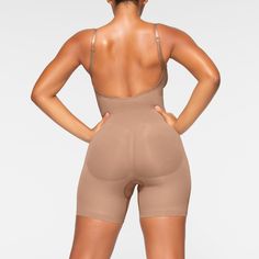 A sculpting bodysuit that sculpts silhouette, cinches waist, and smooth thighs while providing support and lift for your curves. Featuring a deep scoop back that makes it the perfect backless shapewear option. | SKIMS Low Back Mid Thigh Bodysuit | Medium Neutral | Seamless Sculpt Low Back Shapewear Wedding, Low Back Shapewear, Backless Shapewear, Backless Body Shaper, Sculpting Bodysuit, Backless Bodysuit, Body Shapers, Fall Shopping, Cinched Waist