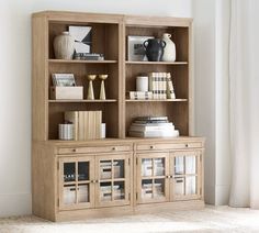 a wooden bookcase filled with lots of books on top of a carpeted floor