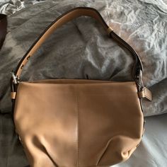 Beautiful Tan Coach Original Purse That Was Never Used. It Has Adjustable Strap And A Zipper Outside And Inside Pocket. It Has 2 Other Pockets That You Can Slide Things In. It’s About 15 1/2 Inches Long And About 12 Inches Wide. In Beautiful Condition! Bucket-shaped Hobo Bag With Snap Closure, Elegant Hobo Bag With Snap Closure For Shopping, Coach Beige Bag With Snap Closure, Beige Coach Bag With Snap Closure, Elegant Beige Shoulder Bag With Snap Closure, Tan Hobo Bag For Travel, Hobo Bag With Silver-tone Hardware For Errands, Navy Purse, Tan Purse