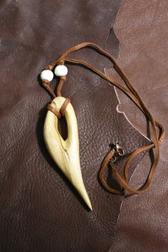 a banana and some beads on a brown leather bag