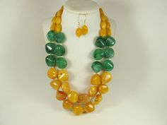 "Contains small parts! Not for children! Choking Hazard!Chunky gold yellow marigold  and forest green necklace, multi strand statement yellow necklace, beaded yellow necklace, big gold  beads, green  statement jewelry, matching earrings  A bold and dramatic statement necklace featuring acrylic forest green chip  beads and huge marigold  yellow  oval beads. 3 strands, light weight. Gold  plated lobster clasp Measurements: 19\" (47 cm) plus 3\" extender Each piece of jewelry from my shop comes bea Yellow Marigold, Jewelry Matching, Marigold Yellow, Necklace Big, Yellow Necklace, Oval Beads, Necklace Beaded, Chip Beads, Green Necklace