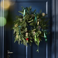 a christmas wreath hanging on the front door