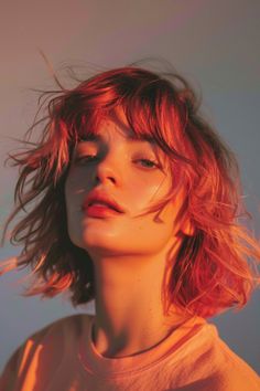 Portrait of a young woman with tousled hair bathed in warm, sunset lighting. Short Hair Heart Shaped Face, Hair Dyed, Find Hairstyles