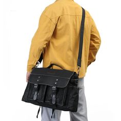 a man in yellow jacket carrying a black bag with multiple compartments on the front and side