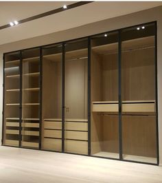 an empty walk in closet with sliding glass doors and lights on the ceiling above it