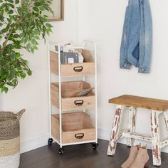 a wooden bench sitting next to a white shelf filled with boxes and baskets on top of it