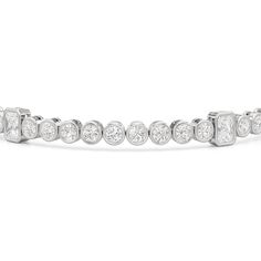 A sweeping sense of sophistication is deeply embedded within this tennis bracelet's timeless design. Bezel-set radiant and round diamonds line up to form a pattern, leading the eye from one flash of sparkle to another. Fastening the bracelet onto your wrist is a secure tongue-and-clip clasp. Luxury Diamond White Tennis Bracelet With Bezel Setting, Luxury Tennis Bracelet In Diamond White With Bezel Setting, Timeless Diamond Tennis Bracelet With Bezel Setting, Timeless Diamond Channel Set Tennis Bracelet, Timeless Round Channel Set Bracelets, Timeless Round Channel Set Bracelet, Channel Set Round Cut Diamond Bracelet, Timeless Channel Set Round Bracelet, Timeless Channel Set Bracelet