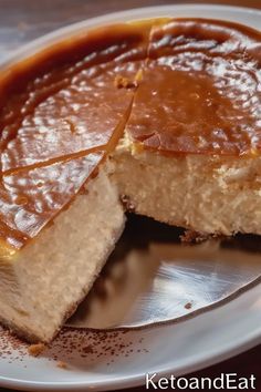 a piece of cheesecake on a plate with caramel sauce in the middle and one slice missing