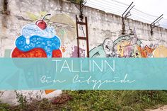 a wall with some graffiti on it and the words talllinn en d'artique