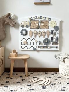 a toy horse is standing next to a wall mounted with clocks and magnets on it