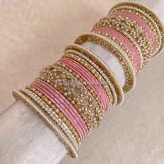 A Pair of 2 medium Sized stacks of luxurious antique Gold bangles with pretty pink shades, finished with beautiful intricate detailed Champagne Crystal bangles and pearl details. This will make the perfect stack for any Bride or those wanting to make a statement. Pair this with our Rubal Choker Set. Sold as a set for both arms only. Ready to Ship! Antique Gold Bangles, Cristal Champagne, Pink Bangles, Bridal Survival Kit, Bangle Box, Hand Harness, The Bangles, Bridal Choker, Bridal Necklace Set