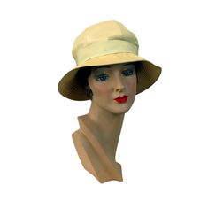 "This 1960s hat is really cute!  Made by Betmar, New York and Paris.  The ivory silk has a beautiful sheen. The brim is top stitched and stiff. A grosgrain ribbon band is threaded through a fabric covered buckle. High crown. Great sun hat!  Measures 20.5\" in circumference.  * Proud member of the Vintage Fashion Guild * For more vintage fashions, visit Vintage Runways' shop at http://www.vintagerunway.etsy.com. Follow on Instagram - instagram.com/vtgrunway Follow on Tumblr - vintagerunwayetsy.tu Cream Brimmed Panama Hat For Kentucky Derby, Cream Cloche Hat With Short Brim For Kentucky Derby, Cream Short Brim Cloche Hat For Kentucky Derby, Cream Sun Hat With Short Brim For Kentucky Derby, Cream Short Brim Sun Hat For Kentucky Derby, Cream Cloche Sun Hat For Beach, Classic Adjustable Cream Sun Hat, Cream Cloche Hat For Summer, Cream Curved Brim Sun Hat For Kentucky Derby