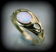 You are a big fan of art nouveau like i am, you'll love this piece ; there is elegancy and a flair of mystery with this style that makes it unique. Here is a ring i create recently to honor this style. The ring is made in solid 10 k or 14 k gold with a beautiful opal. You can order with another stone by sending me a message.  ring dimensions on the top : 10 mm band dimensions : 2 mm Because the environment means a lot to me just like you, all my jewelry is sent with the recyclable material, such as paper bags and boxes of jewels made with 100% recycled cardboxes made with 77% post-consumer fiber and 23% pre-consumer fiber. Also I use small biodegradable plastic bags. I print your invoices on ecological certified paper, earth choice Unique Yellow Gold Oval Moonstone Ring, Unique Oval Yellow Gold Moonstone Ring, Unique Oval Moonstone Ring In Yellow Gold, Collectible Gold Opal Rings, Art Nouveau Yellow Gold Ring, Art Nouveau Gold Ring With Gemstone, Art Nouveau Gemstone Jewelry, Art Nouveau Gemstone Ring Jewelry, Elegant Yellow Gold Jewelry With Artistic Design