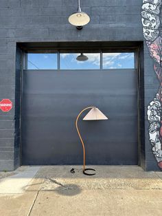 a lamp sitting in front of a garage door