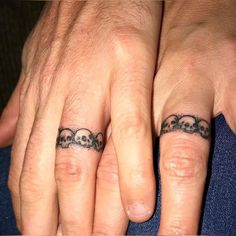 two people with matching tattoos on their fingers