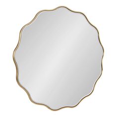 a round mirror with gold trimmings on the edges and an oval shaped frame