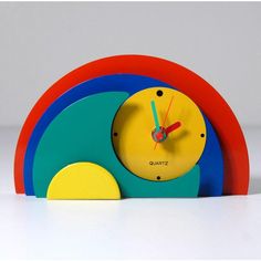 a colorful clock sitting on top of a white table