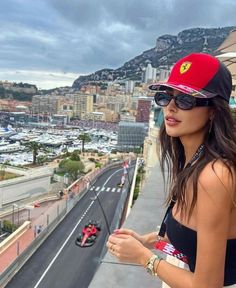 a woman standing on top of a building next to a street