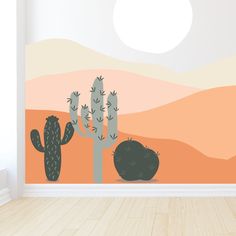 two cactuses in front of a desert landscape wall mural with the sun setting behind them