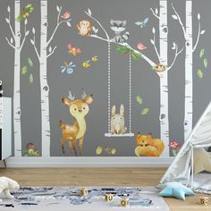 a child's room decorated with woodland animals and trees