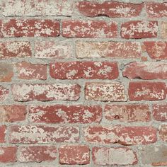 an old brick wall with red and white paint