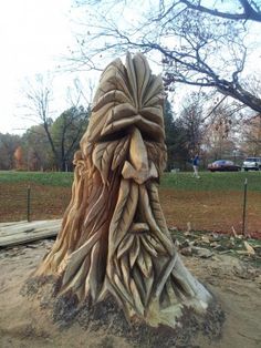 a tree stump that has been carved into the shape of a woman's head