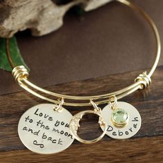 "Check out our Website: ANNIEREH.COM Love you to the moon and back Bracelet, Gold Bangle Charm Bracelet, Gold Name Bracelet, Moon and Back Bangle, Kids Names, Engraved Jewelry This adjustable bracelets is designed to be worn individually or stacked with other bangle bracelets. One size fits all. This listing COMES with the phrase disc, the moon charm and ONE name and ONE birthstone. Add more during check out. Love you to the moon and back gold pendant is stamped with our adorable saying... I lov Adjustable Moon Charm Jewelry For Anniversary, Round Moon Charm Bracelets As Gift, Moon Charm Bracelets As Gift, Adjustable Moon Charm Bracelet, Adjustable Engraved Moon Jewelry, Adjustable Engraved Moon-shaped Jewelry, Personalized Adjustable Moon Shaped Jewelry, Adjustable Personalized Moon-shaped Jewelry, Gold Name Bracelet