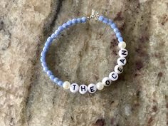 This is a beautiful hand crafted bracelet that is baby blue, and has pearls surrounding the lettering. Custom Name Blue Bracelets With Round Beads, Customized Adjustable Blue Bracelets, Custom Name Blue Beaded Bracelets For Friendship, Custom Name Blue Beaded Bracelet For Friendship, Customized Blue Stretch Bracelet With Round Beads, Everyday Blue Bracelets With Custom Name, Personalized Blue Bracelets For Everyday Wear, Handmade Light Blue Bracelets For Everyday, Customized Blue Stretch Bracelet As A Gift