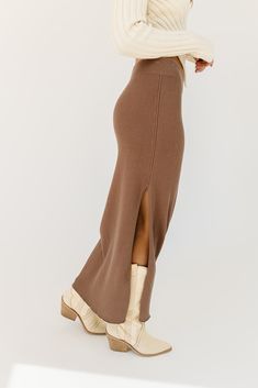 a timeless essential, this chocolate bodycon maxi skirt will transform any spring outfit idea. it features a flirty side slit, + is made with the most luxe ribbed material to stretch + snatch any silhouette. the perfect brown maxi skirt to style up or down for every occasion. mocha // maxi length, elastic waistband, side slit to thigh, ribbed paired with our rhea asymmetrical sweater top model is 5'8" + wearing a small measurements are approximate + taken while laying flat small : waist 28” leng Brown Maxi Skirt, Bodycon Maxi Skirt, Brown Maxi Skirts, Spring Outfit Idea, Asymmetrical Sweater, Knit Maxi Skirt, Small Waist, Outfit Idea, Top Model