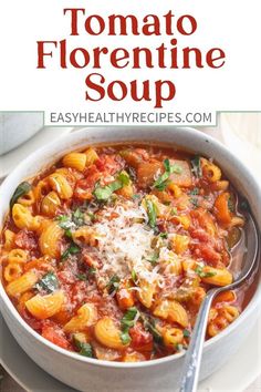 a white bowl filled with pasta and tomato sauce