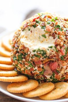 a plate with crackers and a cheese ball on it