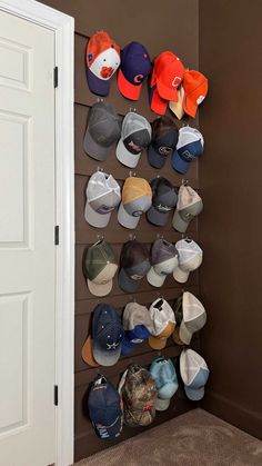 several hats are hanging up on the wall