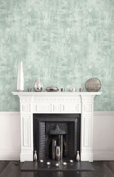 a living room with a fireplace and green wallpaper