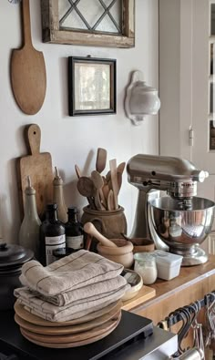 a kitchen counter topped with lots of wooden utensils