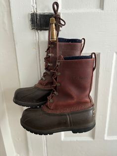 These vintage style L. L. Bean duck boots are a classic style for your wardrobe! Pair with a spring rain jacket, fall utility jacket, or a wintery parka for an almost all season look. These boots are marked men's size 7 and feature a leather shell with a fleece lining. The metal buckles are showing some discoloration and wear as pictured, and the labels on the back of the boot are faded. No holes or stains noted. Items are vintage style and are sold and pictured as is. Please message directly with any questions. Duck Rain Boots Men, Classic Waterproof Hiking Boots For Fall, Classic Waterproof Boots For Fall Outdoor, Classic Waterproof Boots For Fall Outdoor Activities, Classic Waterproof Boots For Outdoor Fall Activities, Classic Waterproof Boots For Winter Hiking, Classic Weatherproof Winter Boots, Classic Insulated Waterproof Boots For Fall, Classic Weatherproof Boots For Fall