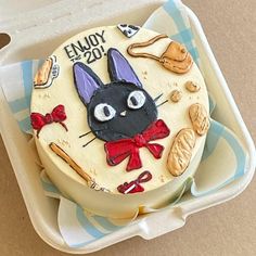 a cake decorated with an image of a cat and other items in the shape of a hat