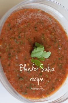 a bowl filled with sauce and garnish on top of a table