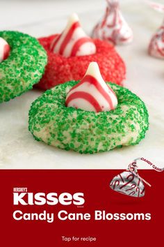 candy cane blossoms are on display in front of red and white candies with green sprinkles